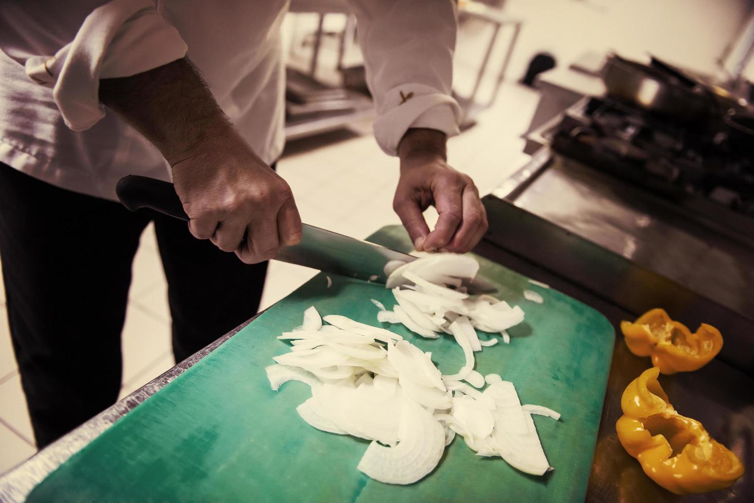 Chef hands cutting fresh and delicious vegetables photo