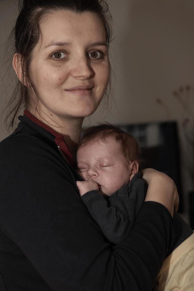 mother is playing with baby at home photo