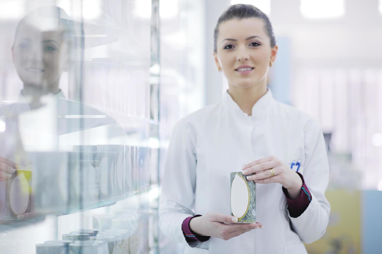 pharmacist chemist woman standing in pharmacy drugstore photo