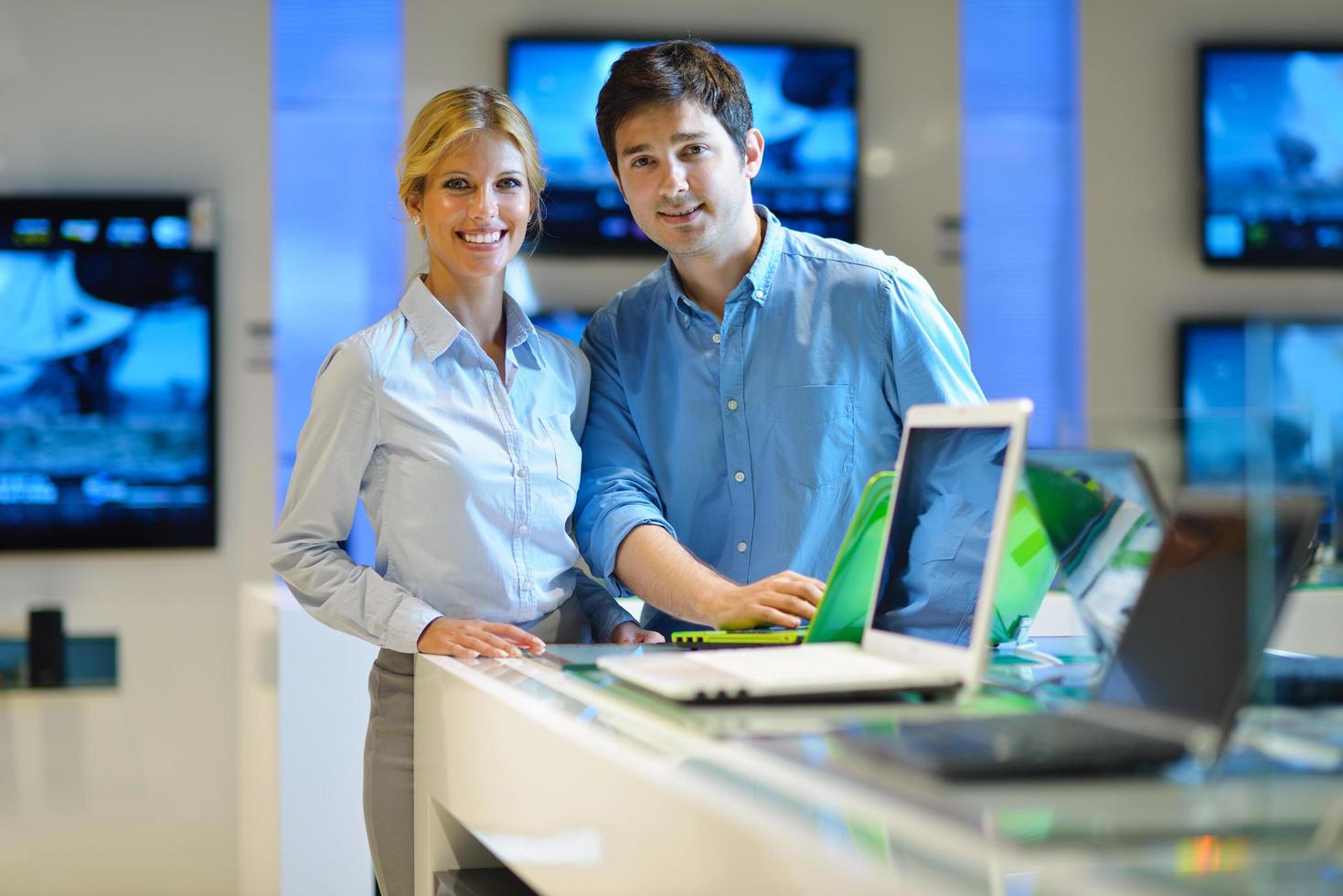 People in electronics store photo