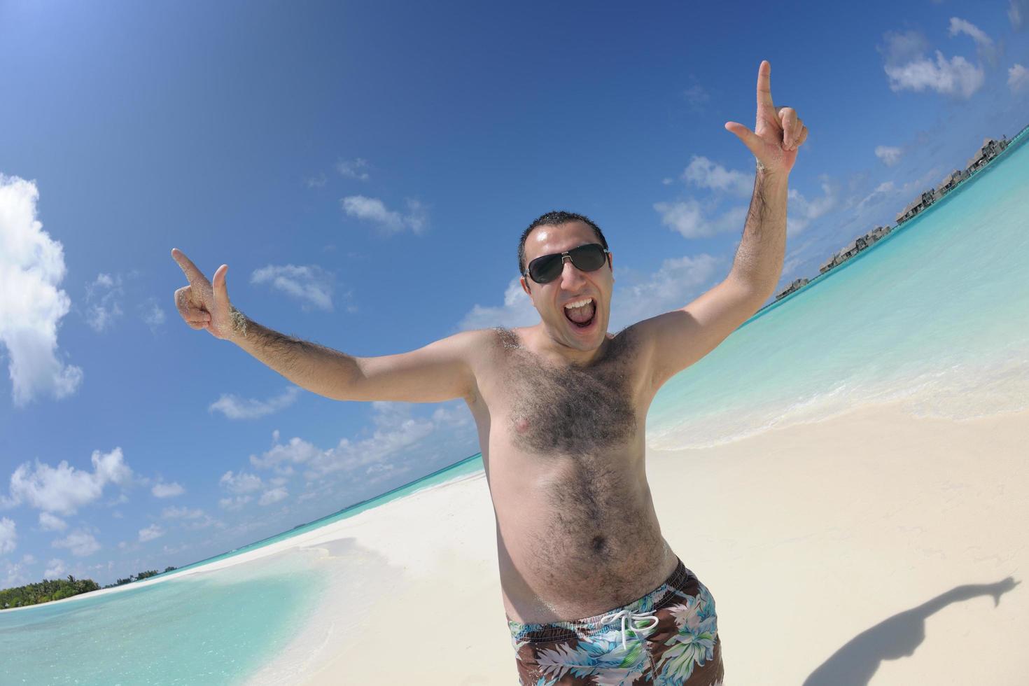 young man have fun and relax on beach photo