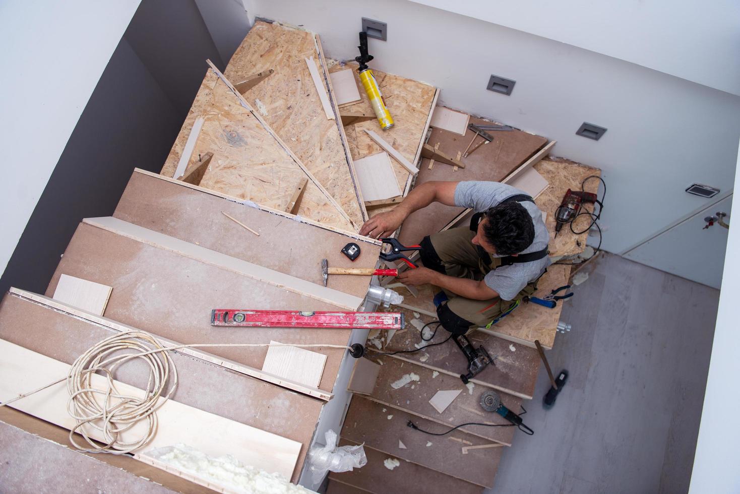 carpenter installing wooden stairs 11927934 Stock Photo at Vecteezy