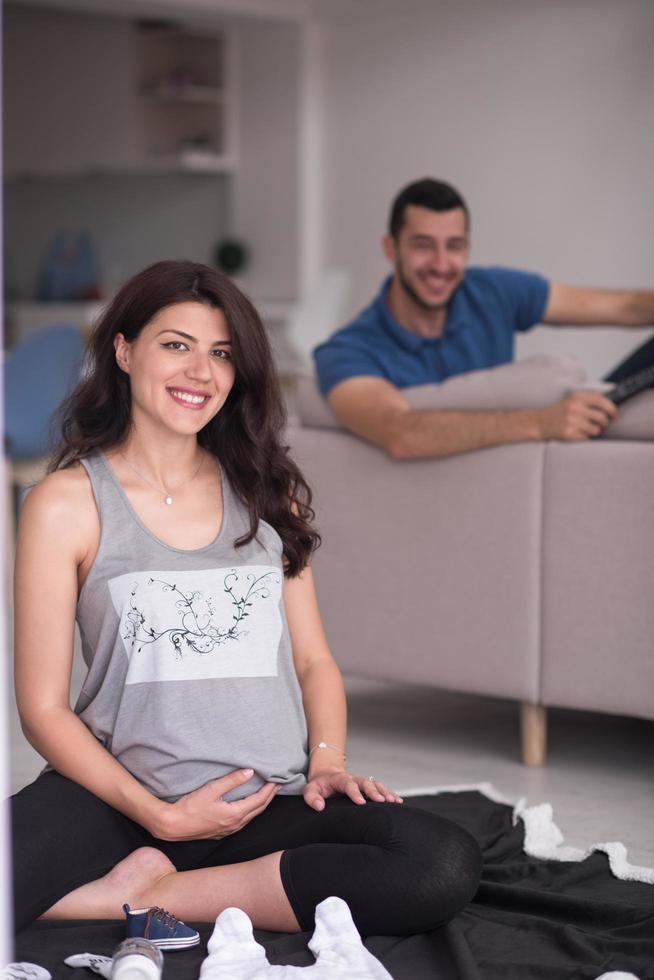 pregnant couple checking a list of things for their unborn baby photo