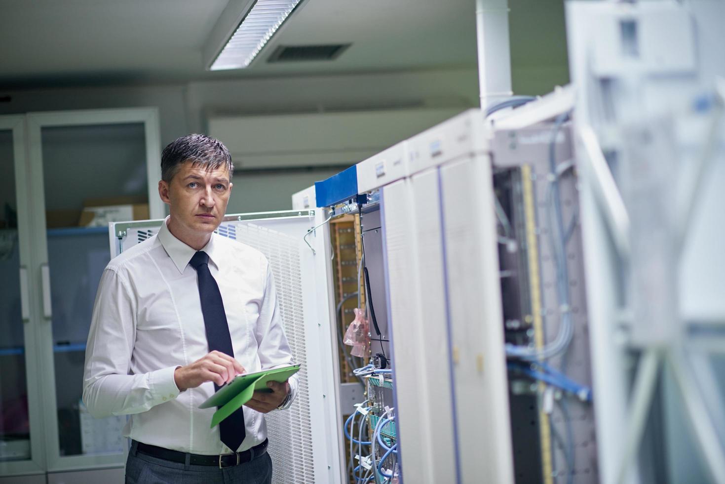 network engineer working in  server room photo