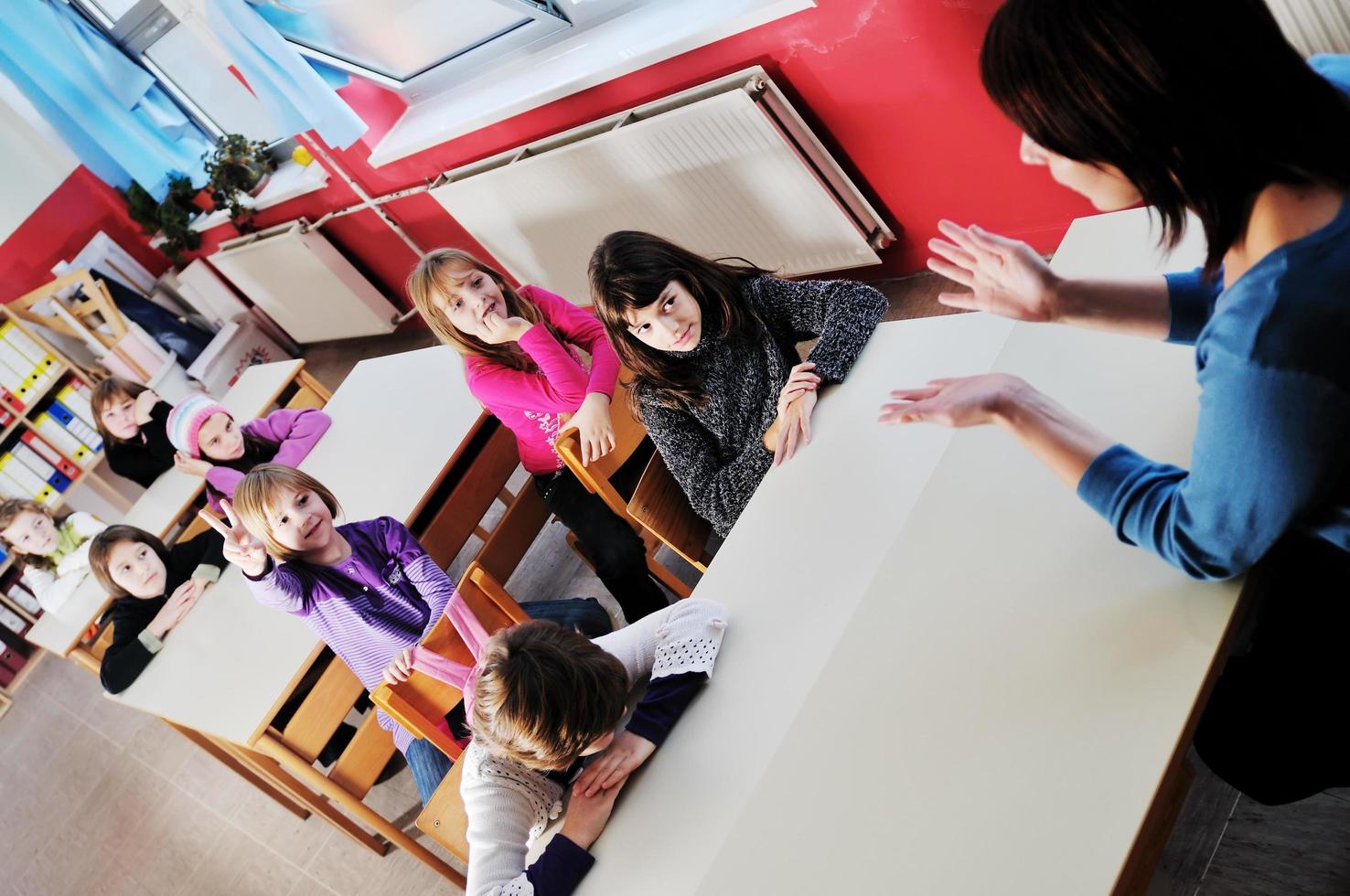 happy teacher in  school classroom photo