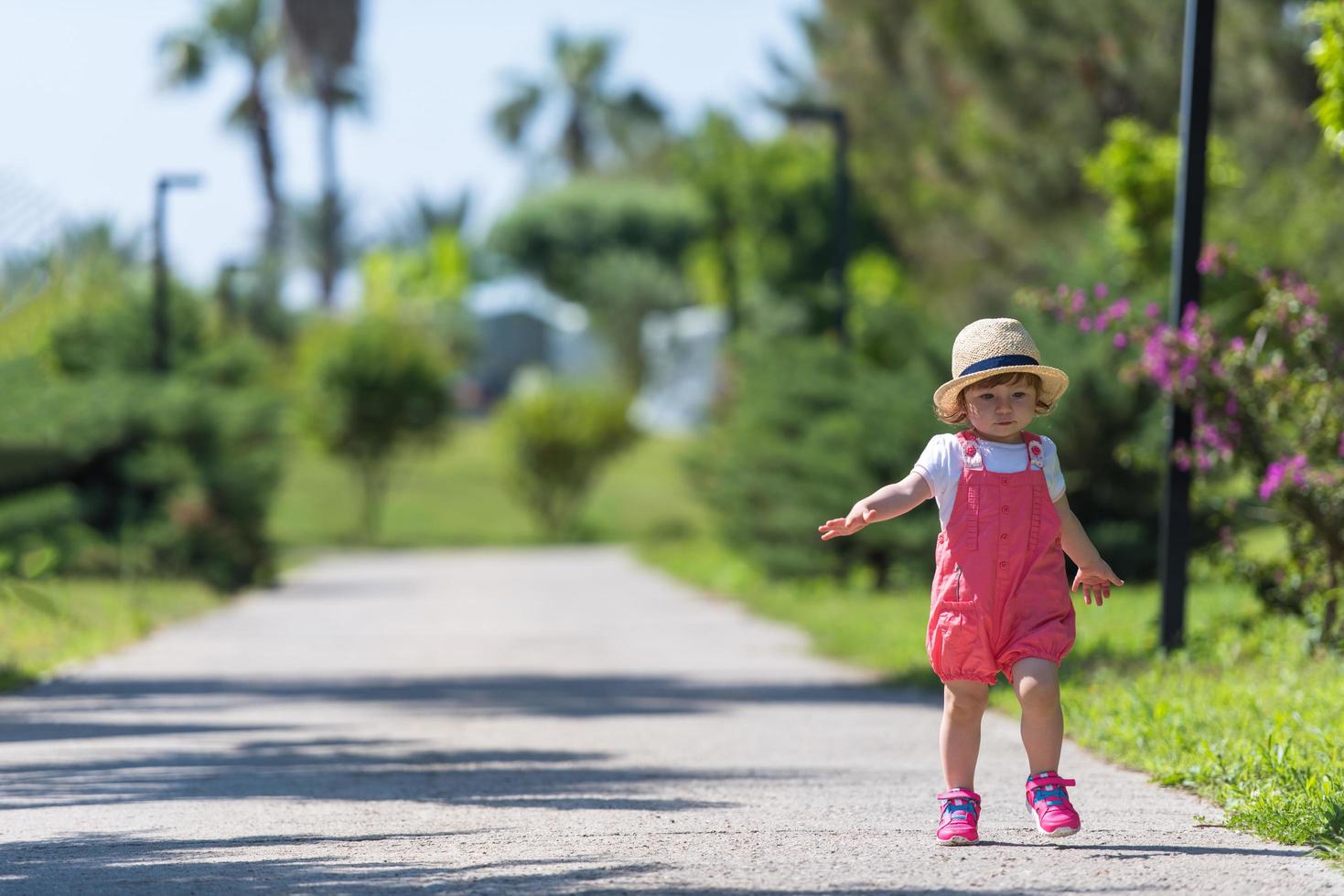 little girl runing in the summer Park photo