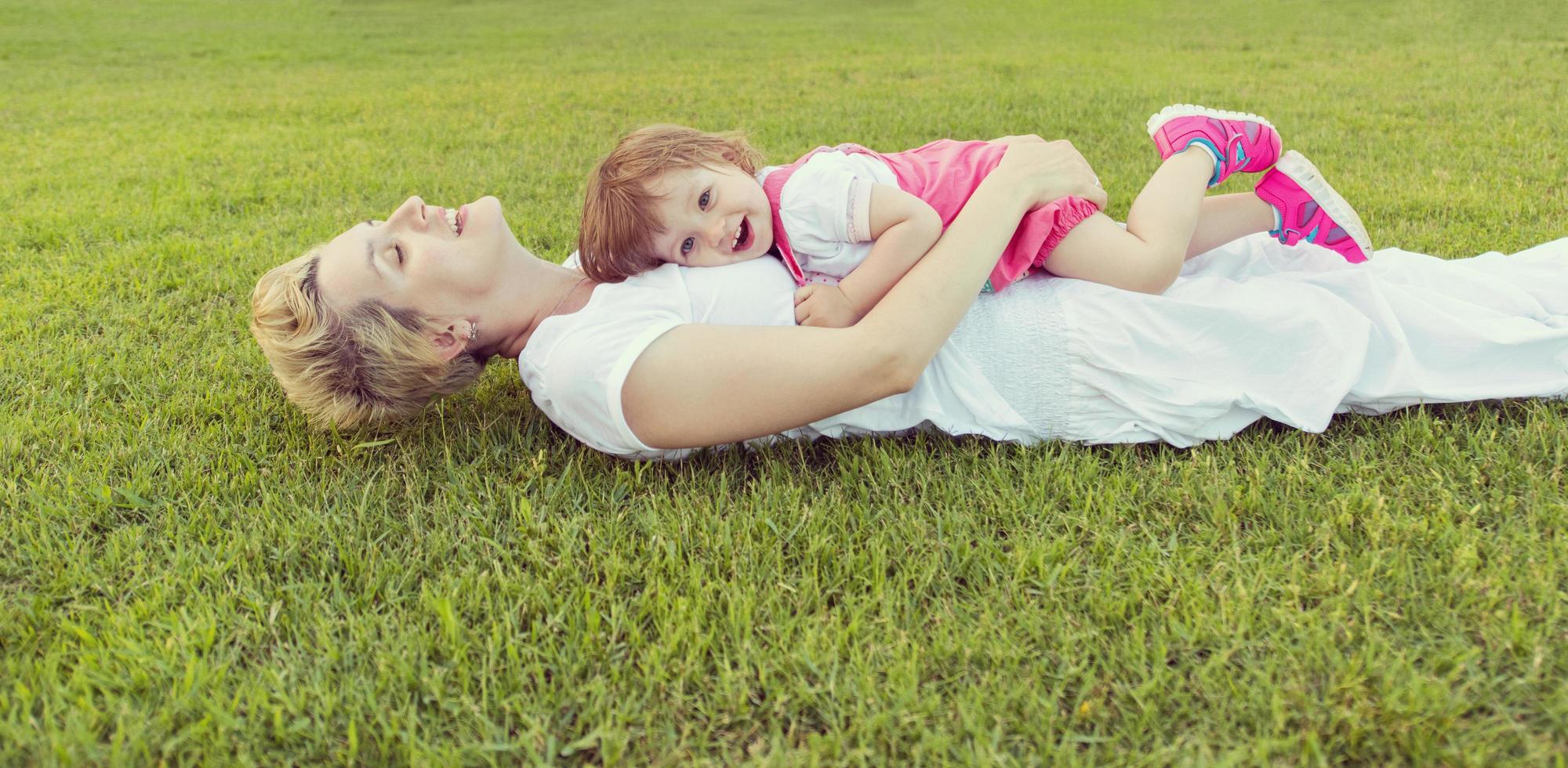mother and little daughter playing at backyard photo