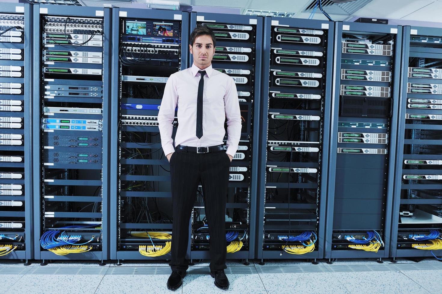 young it engineer in datacenter server room photo