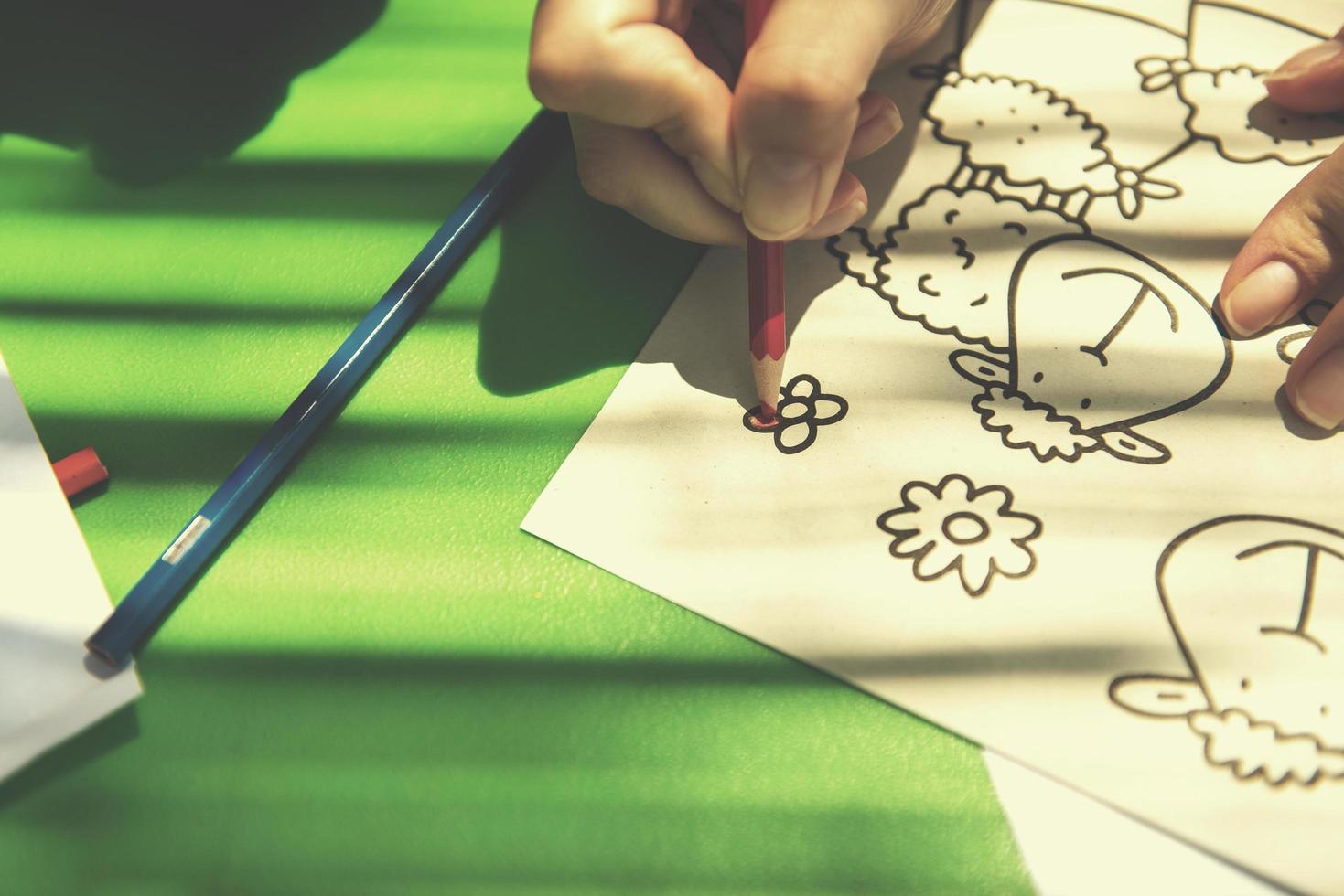 closeup of hands drawing a colorful pictures photo