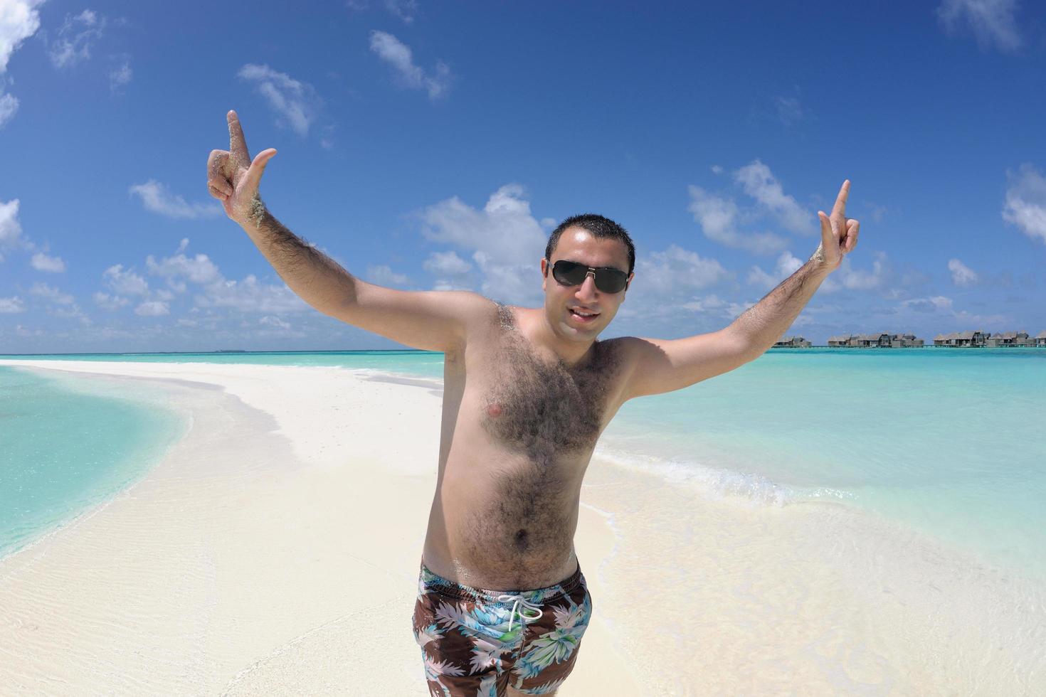 young man have fun and relax on beach photo