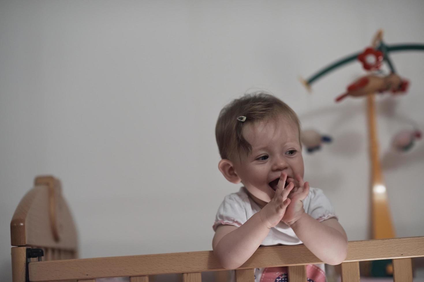 cute  little one year old baby and making first steps in bed photo