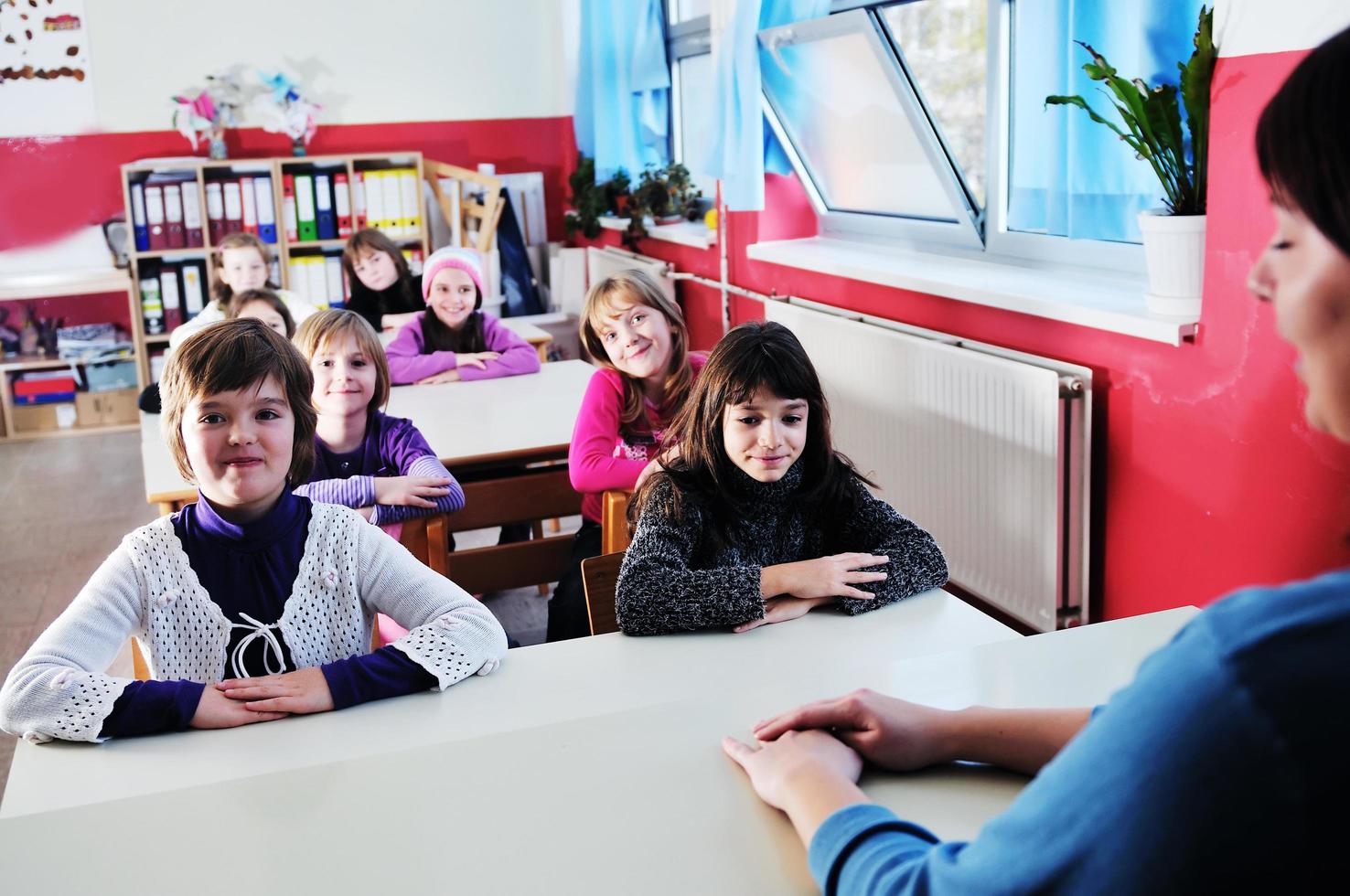 happy teacher in  school classroom photo