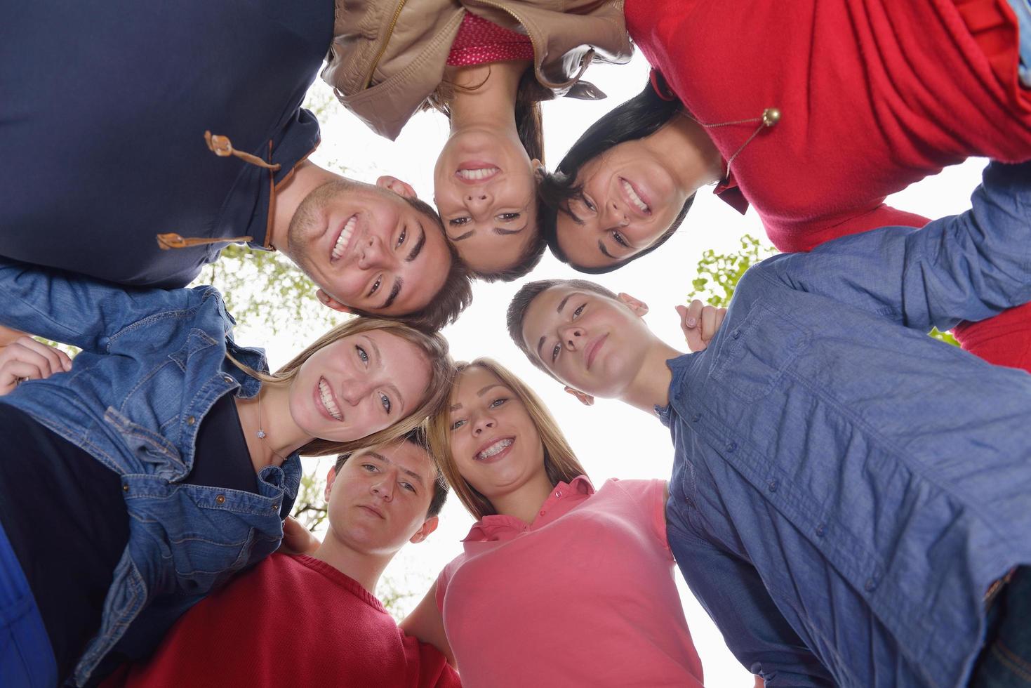 young friends staying together outdoor in the park photo