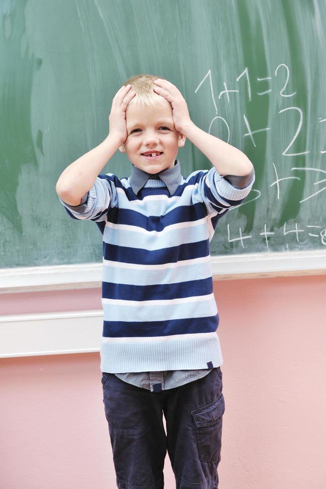 happy young boy at first grade math classes photo