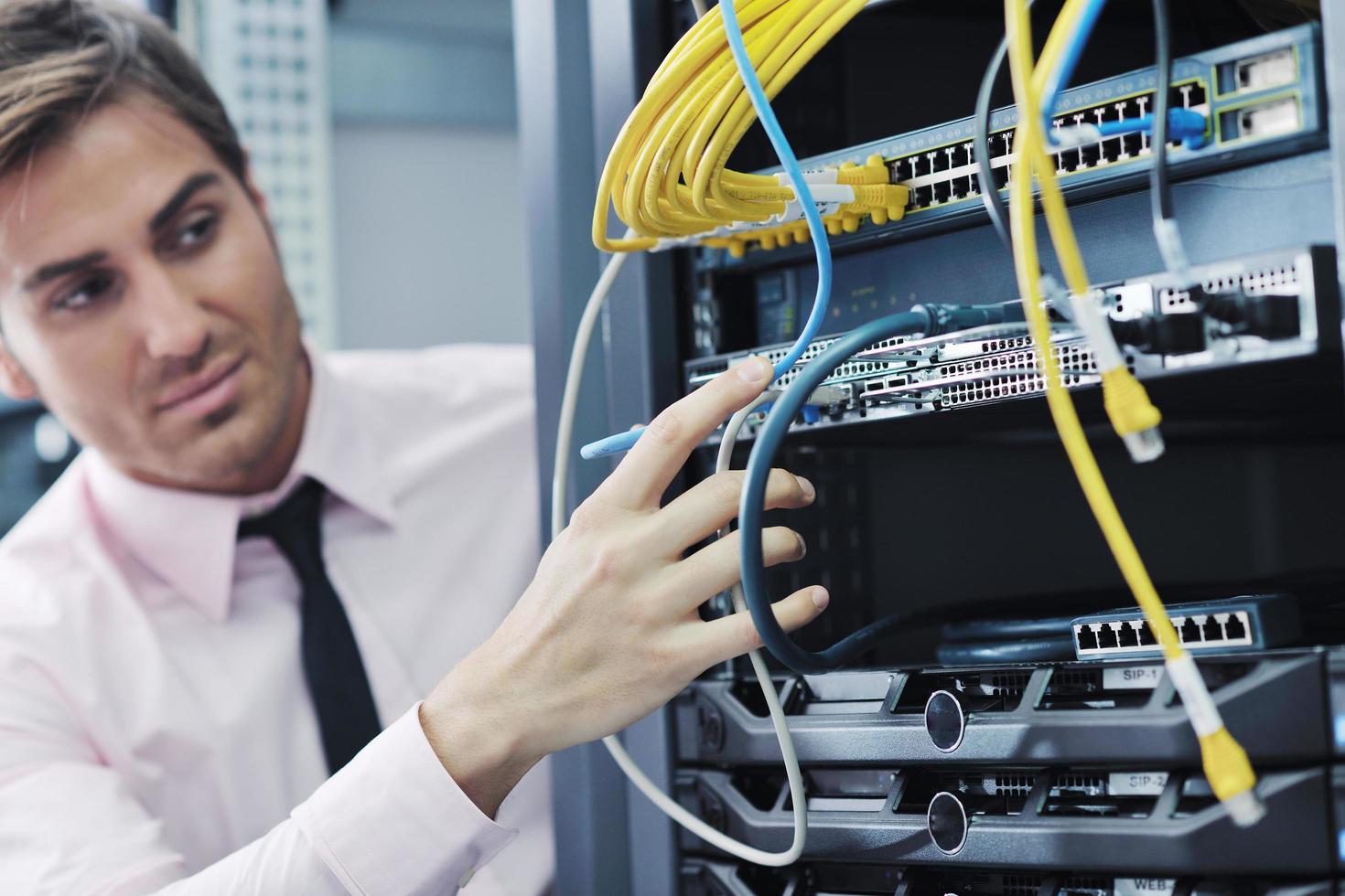 young it engeneer in datacenter server room photo