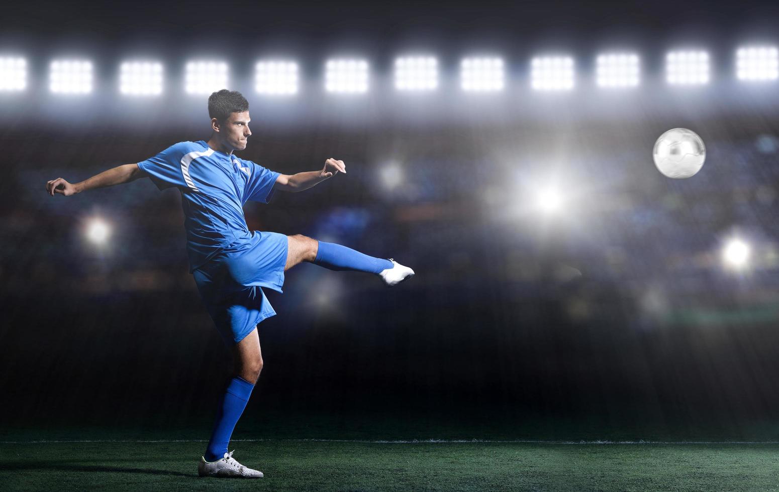 soccer player in front of big modern stadium with flares and lights photo