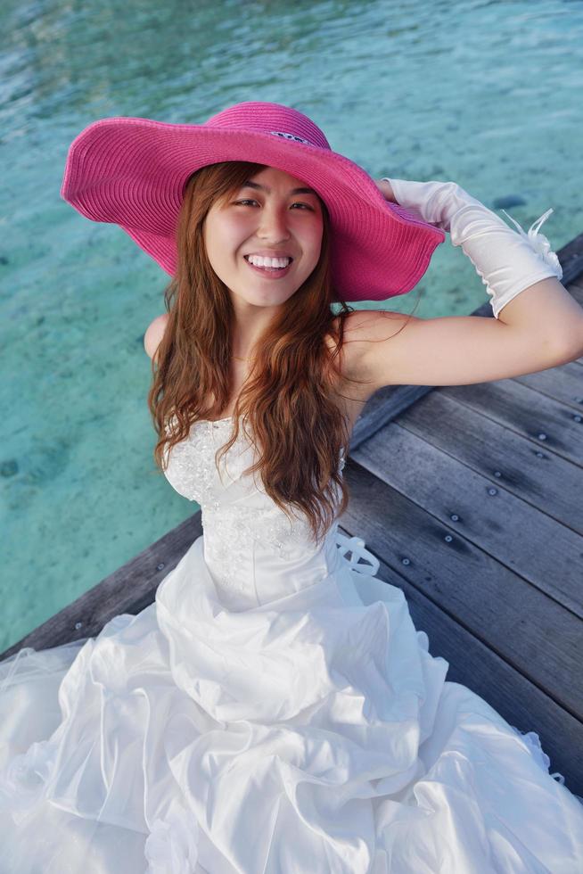 asian bride on beach photo