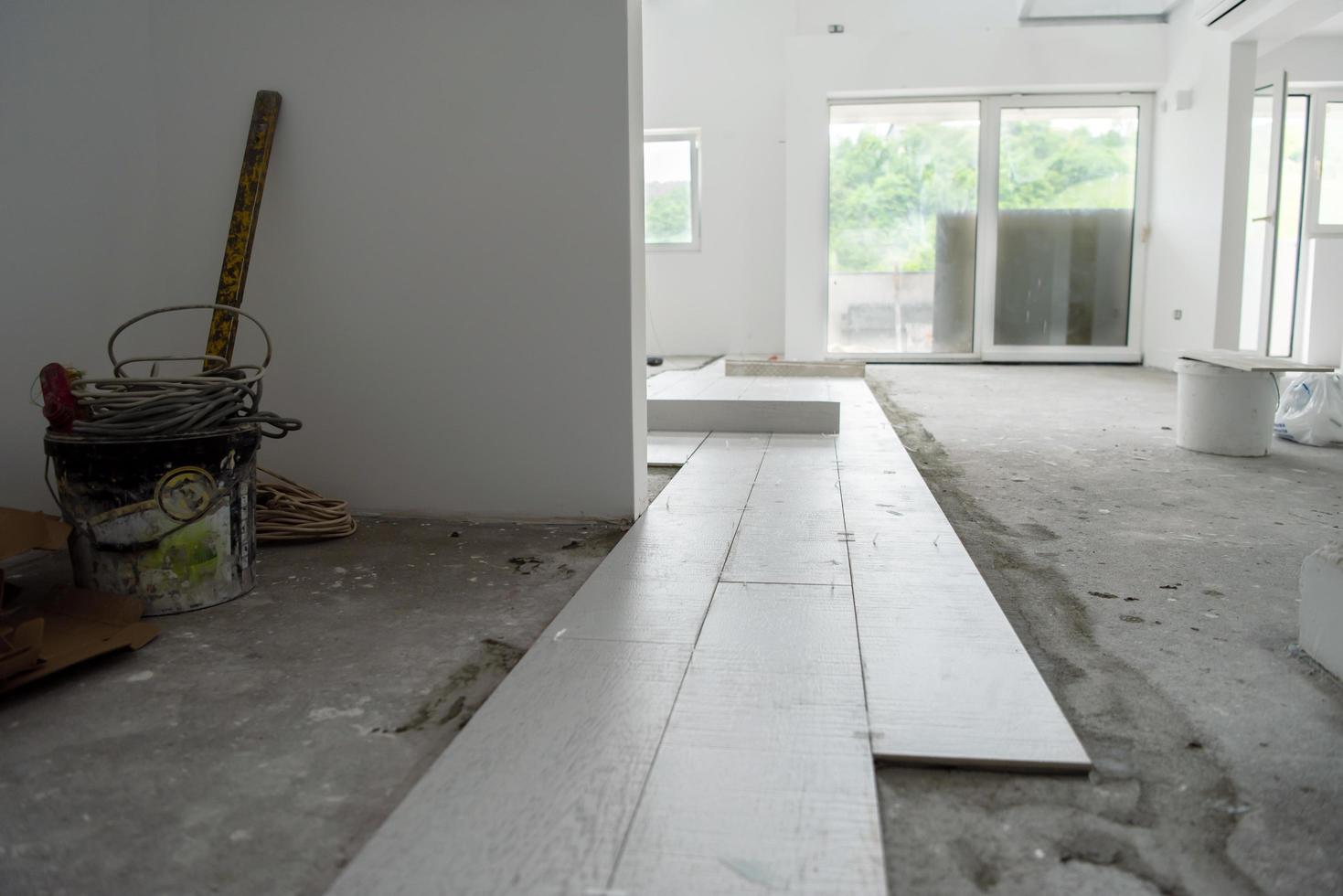 Ceramic wood effect tiles and tools for tiler on the floor photo