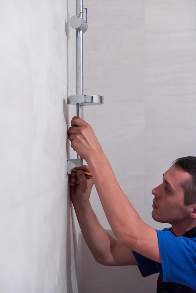 professional plumber working in a bathroom photo