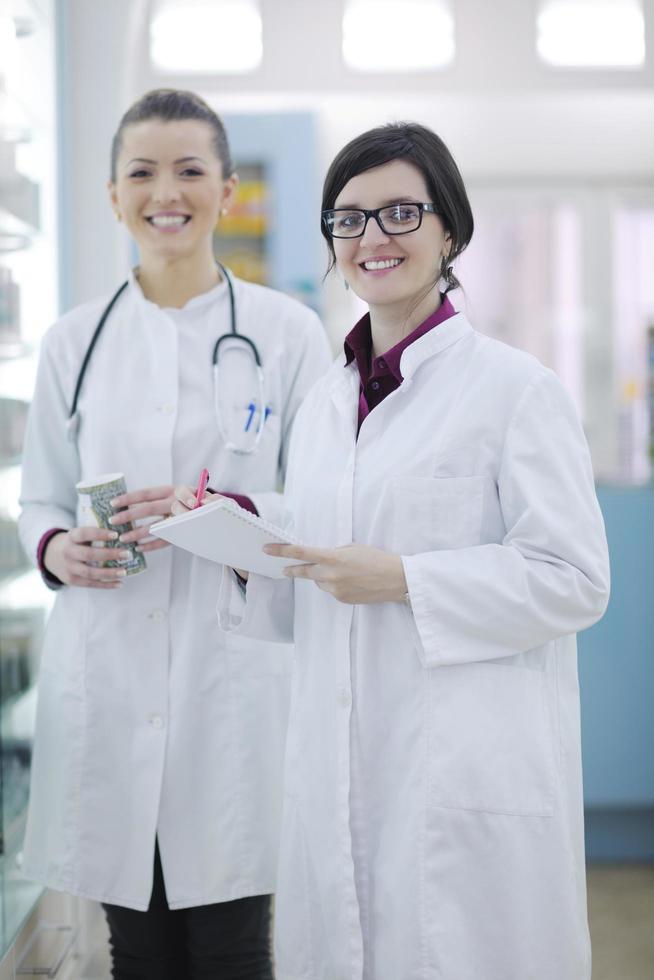 team of pharmacist chemist woman  in pharmacy drugstore photo