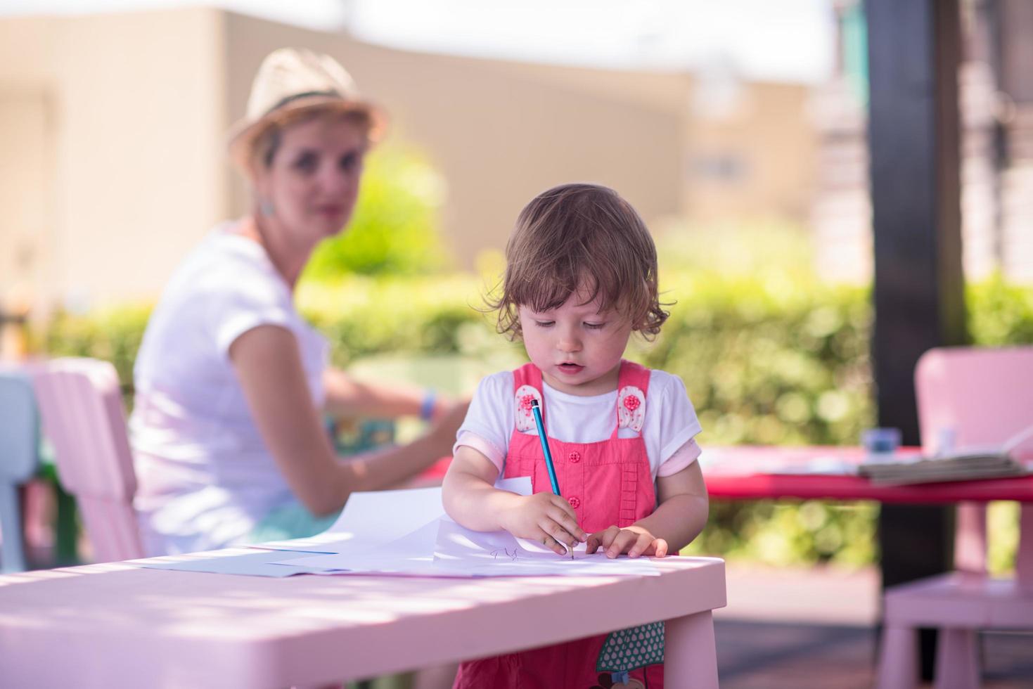 mom and little daughter drawing a colorful pictures photo