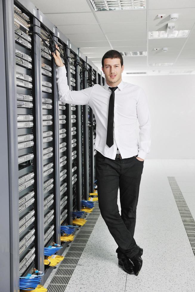 young engeneer in datacenter server room photo