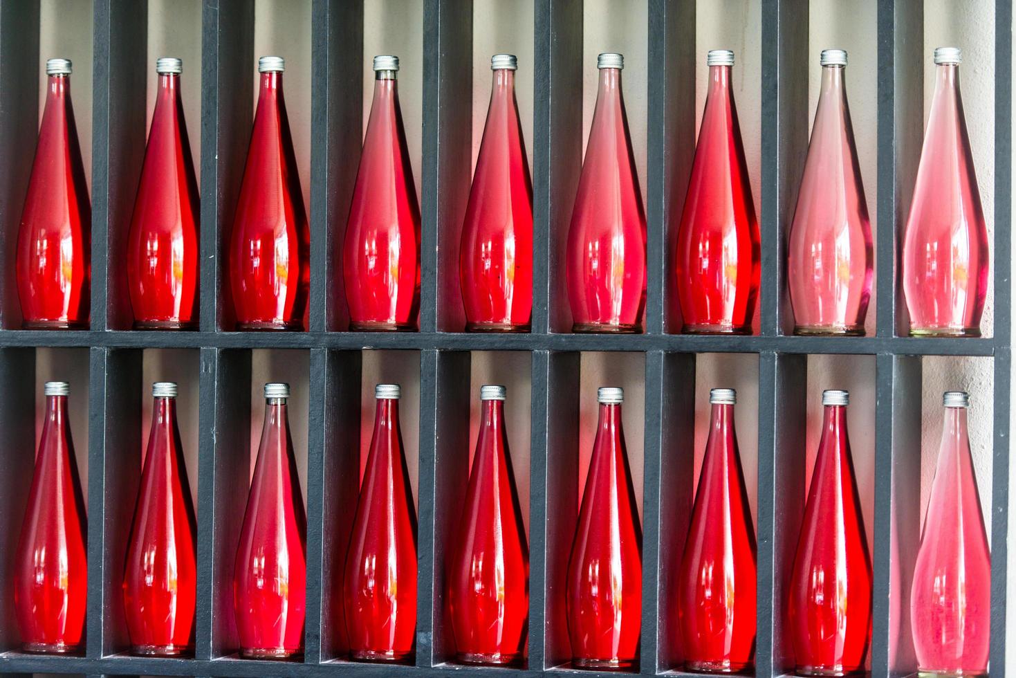 bottles of red juice in modern restaurant photo