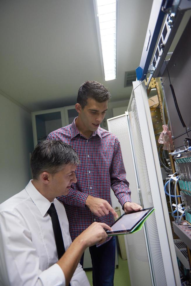 network engineers in server room photo