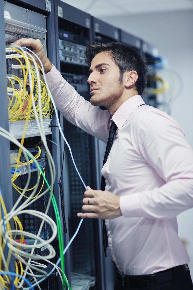 young it engeneer in datacenter server room photo