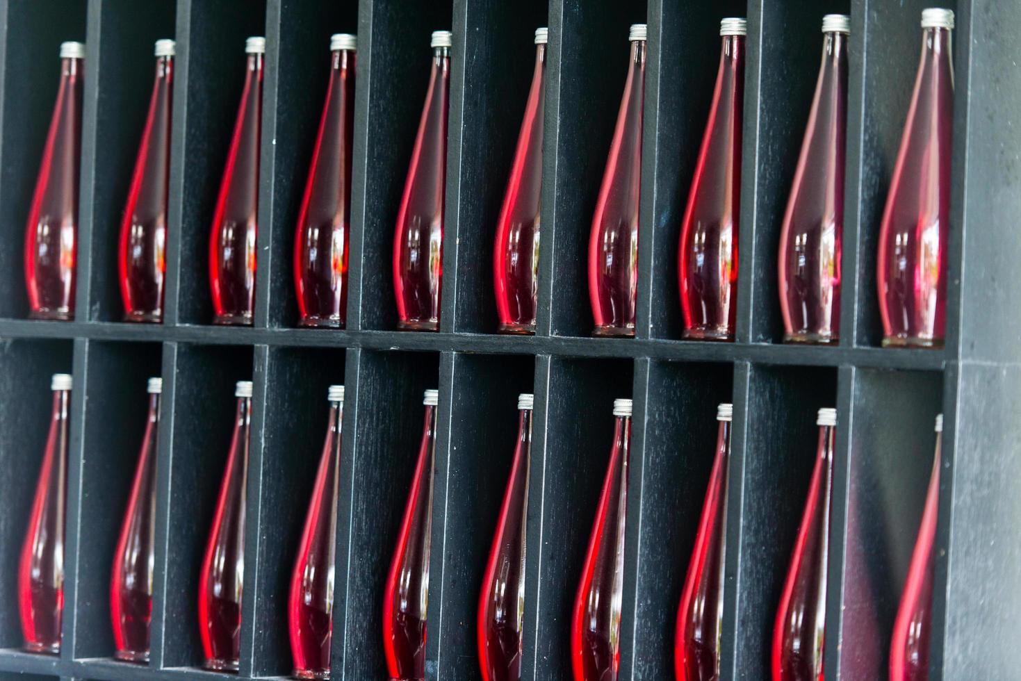 bottles of red juice in modern restaurant photo