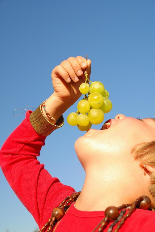 happy girl with grape outside photo