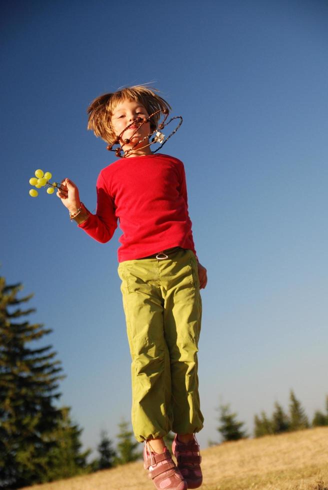 happy child jumping in nature photo