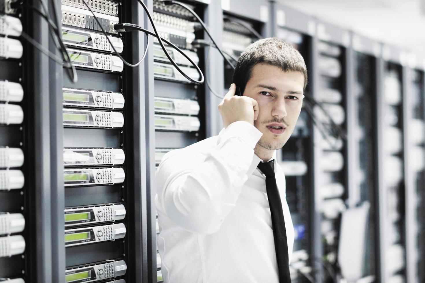 it engeneer talking by phone at network room photo