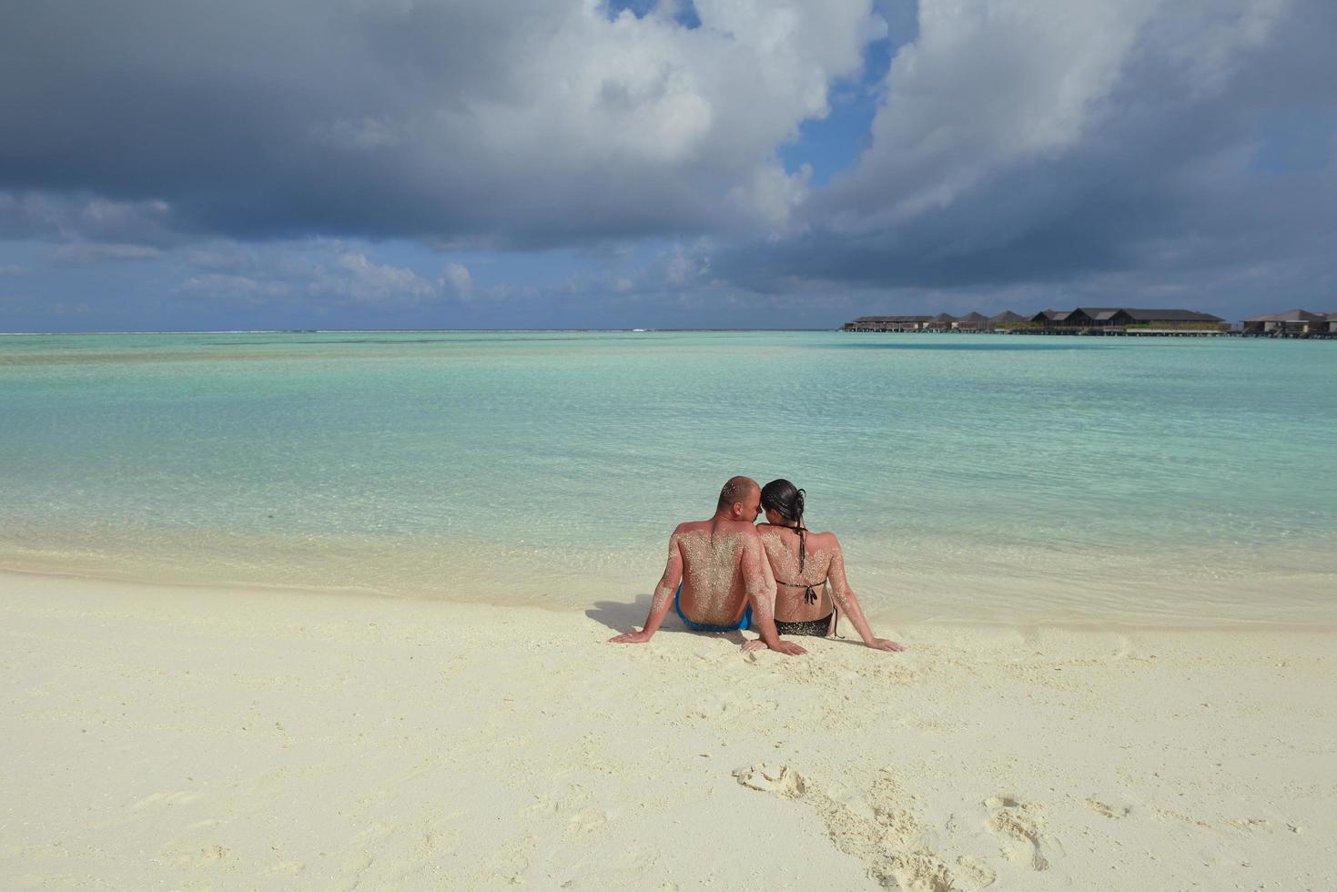 happy young couple have fun on beach photo
