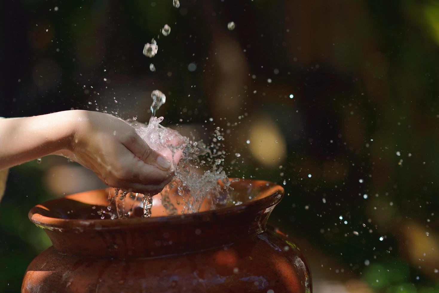 splashing fresh water on woman hands photo