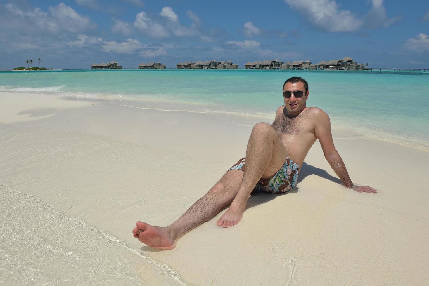 young man have fun and relax on beach photo