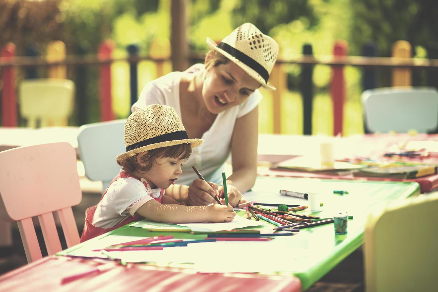 mom and little daughter drawing a colorful pictures photo