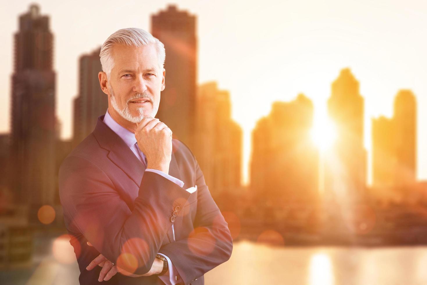 Senior businessman in front of the big city photo