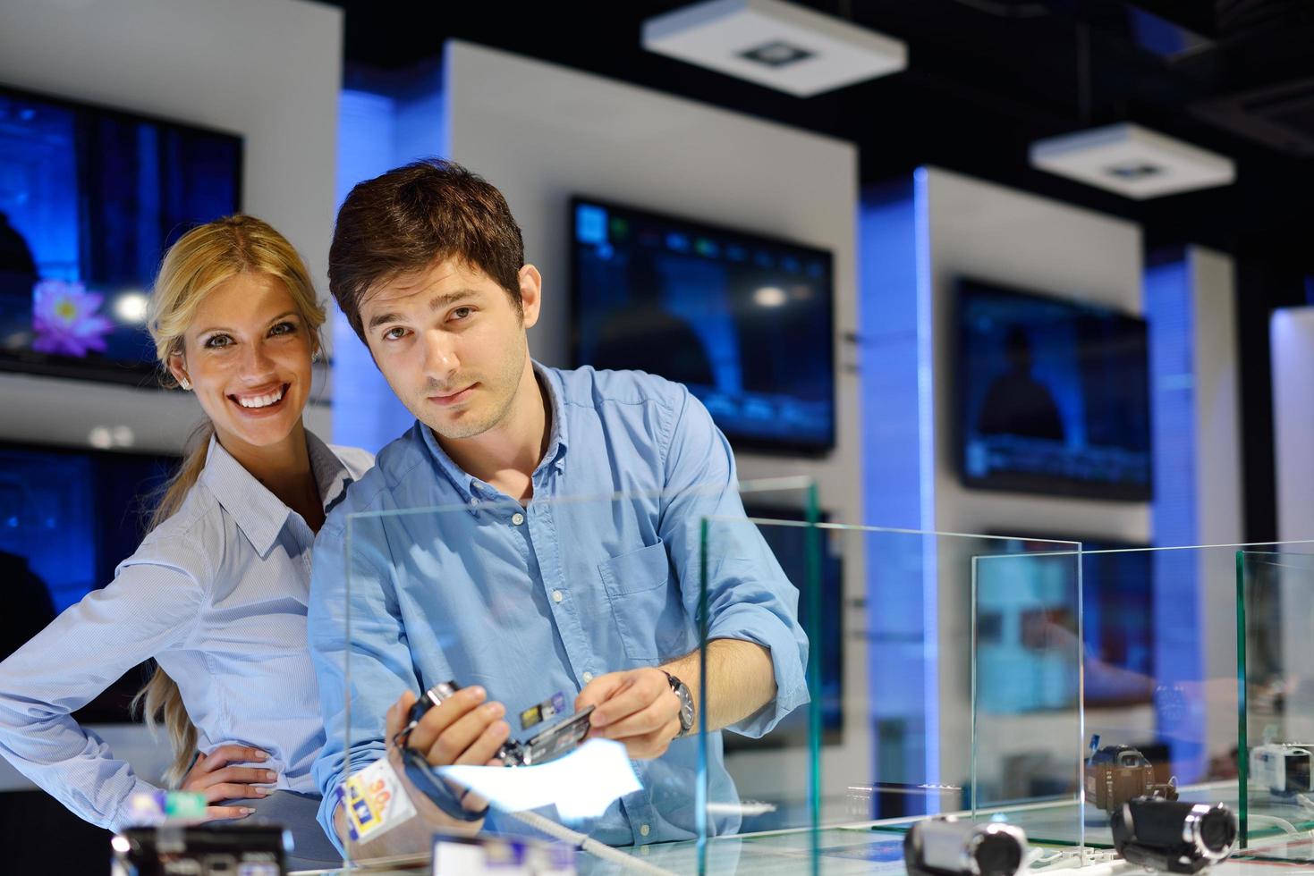People in electronics store photo