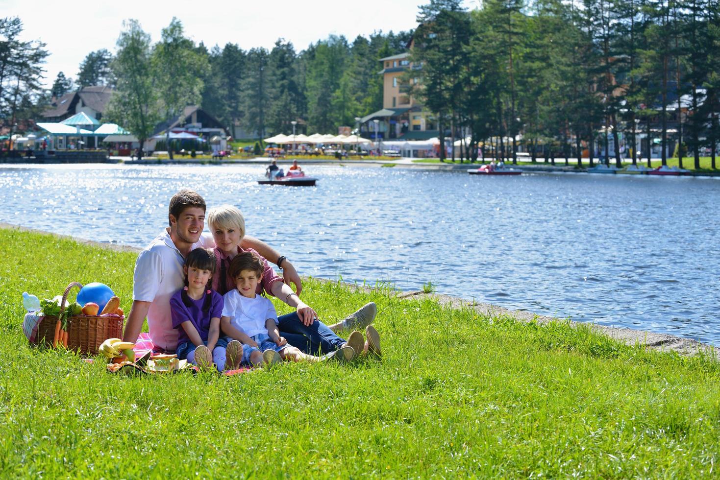 Happy family playing together in a picnic outdoors photo