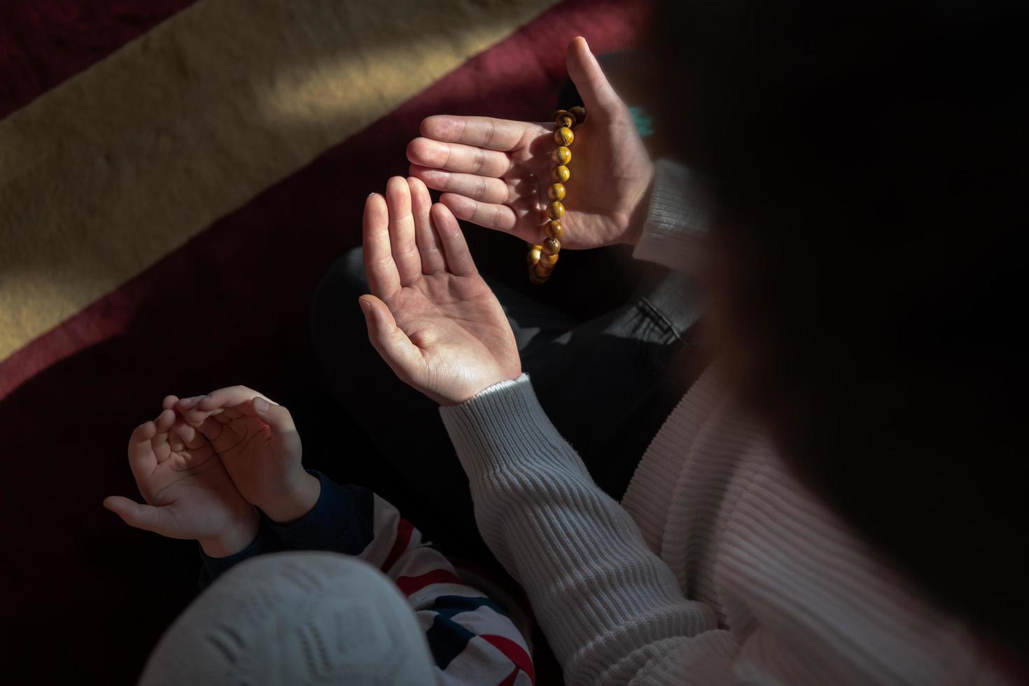 muslim prayer father and son in mosque prayingtogether, islamic education concept photo
