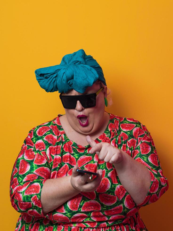 Blonde plus size woman having conversation talking by smartphone over yellow background smiling with an idea or question pointing finger with happy face, number one photo