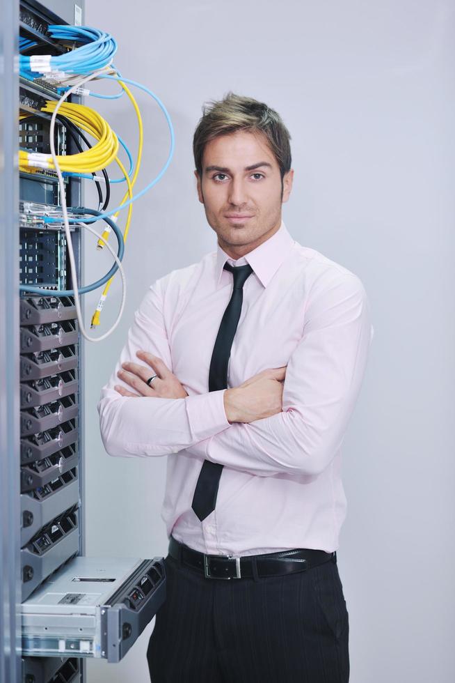 young it engineer in datacenter server room photo