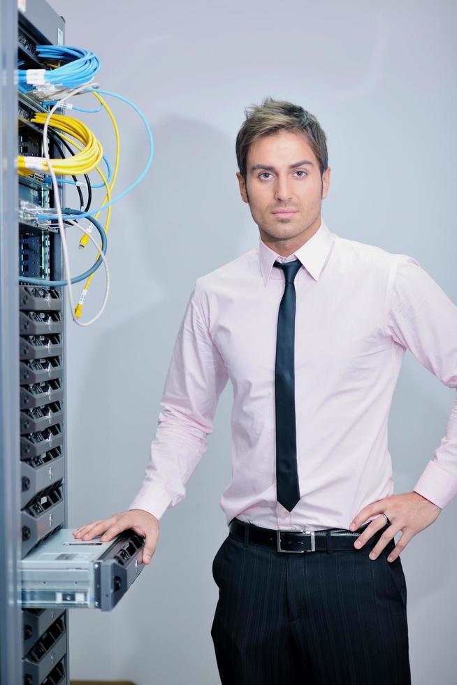 young it engineer in datacenter server room photo