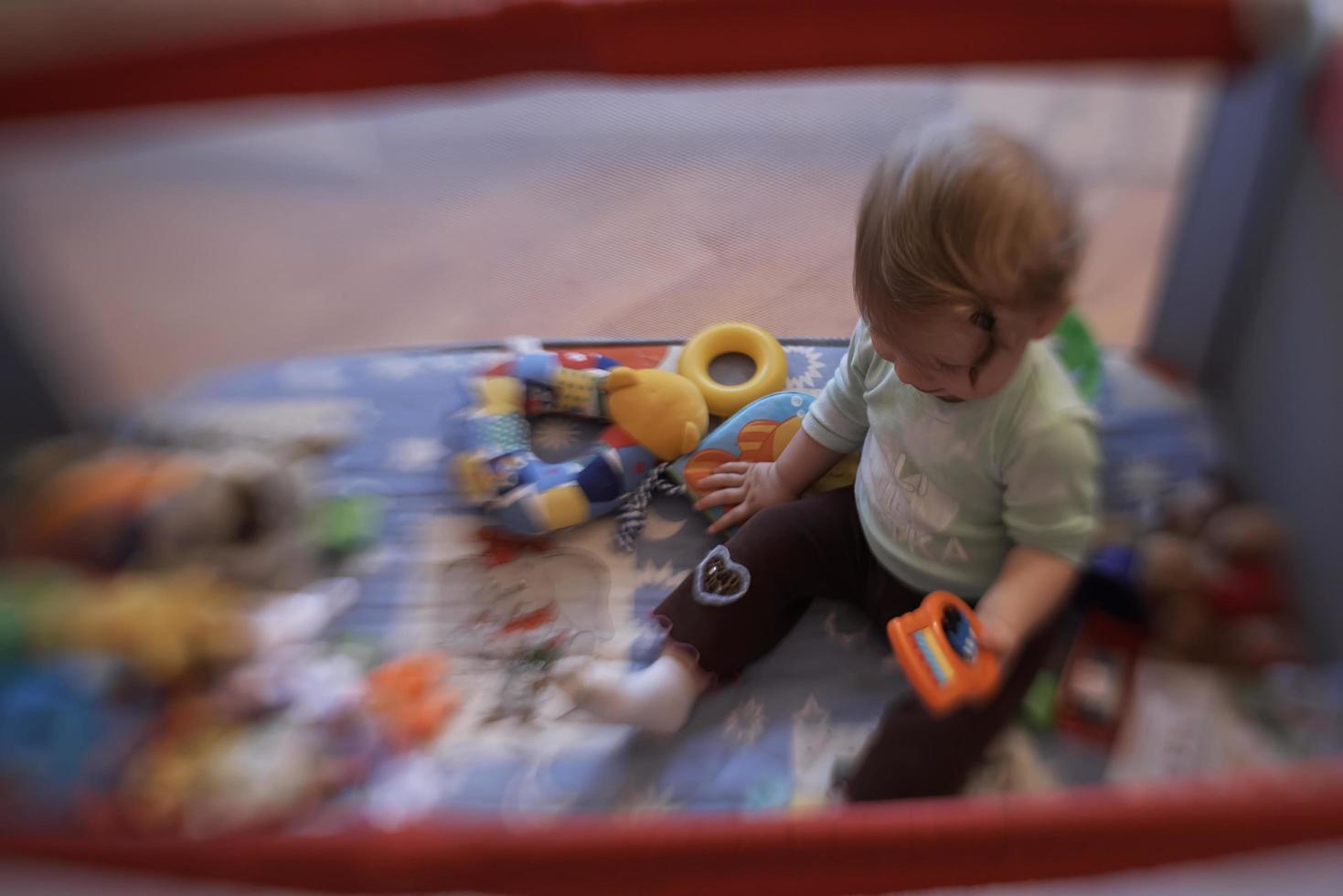 cute  little  baby playing in mobile  bed photo