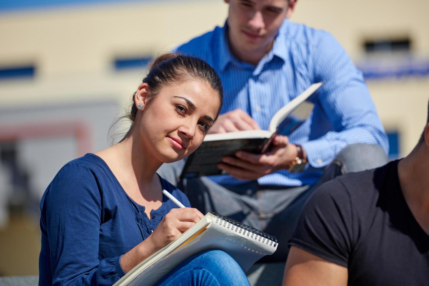 students outside sitting on steps photo