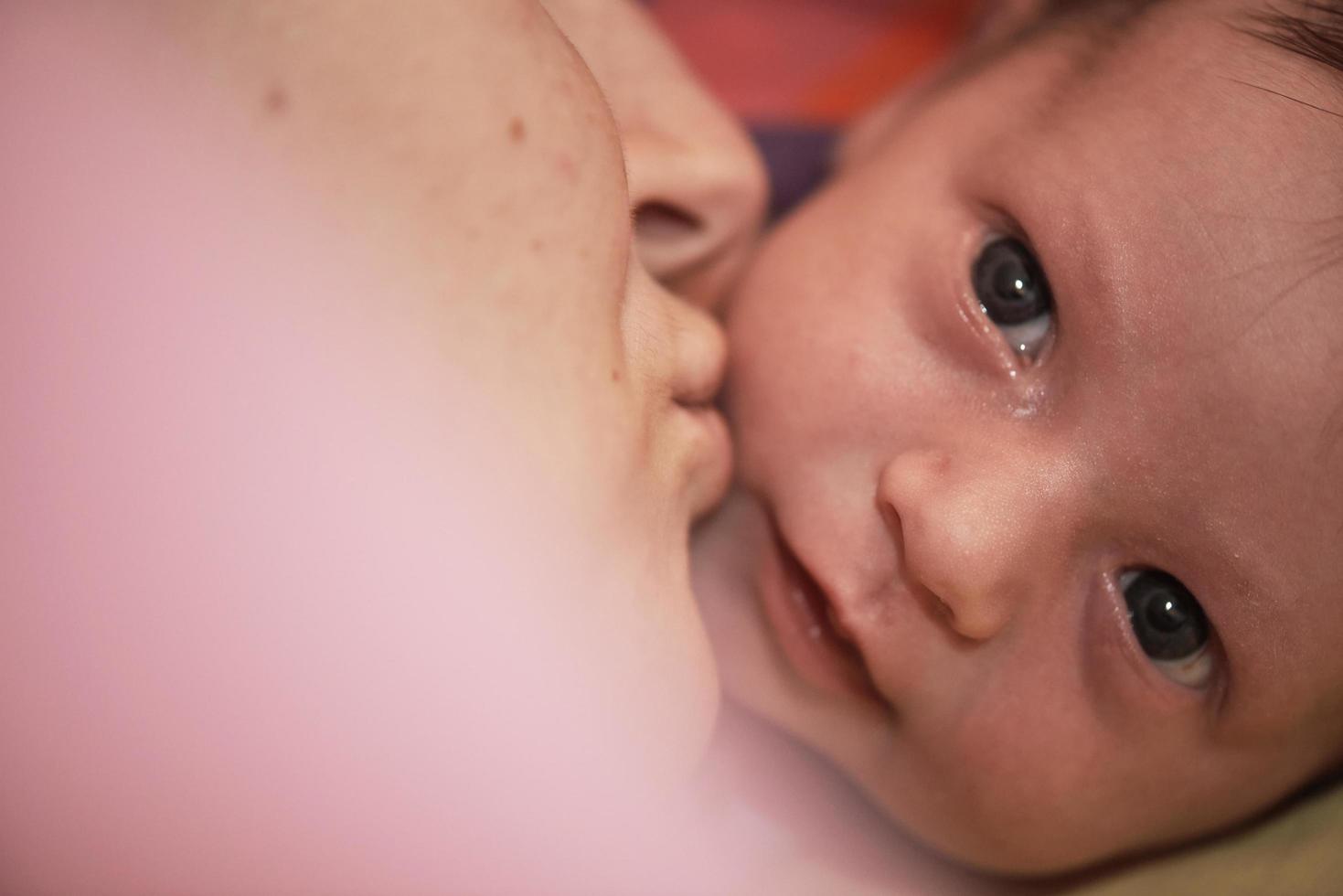 One month newborn baby sleeping  in bed photo