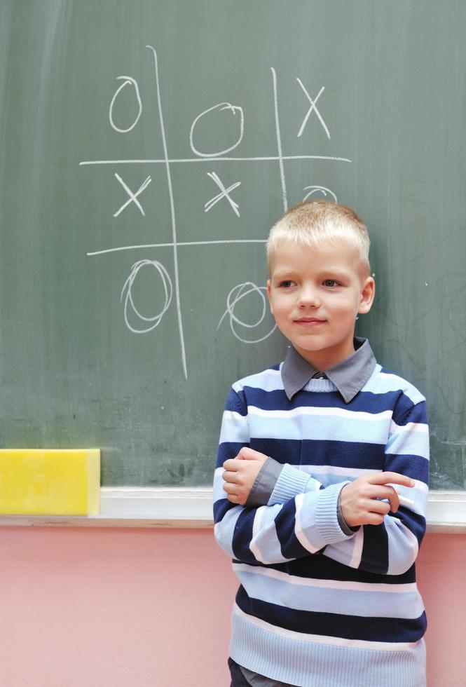 happy young boy at first grade math classes photo