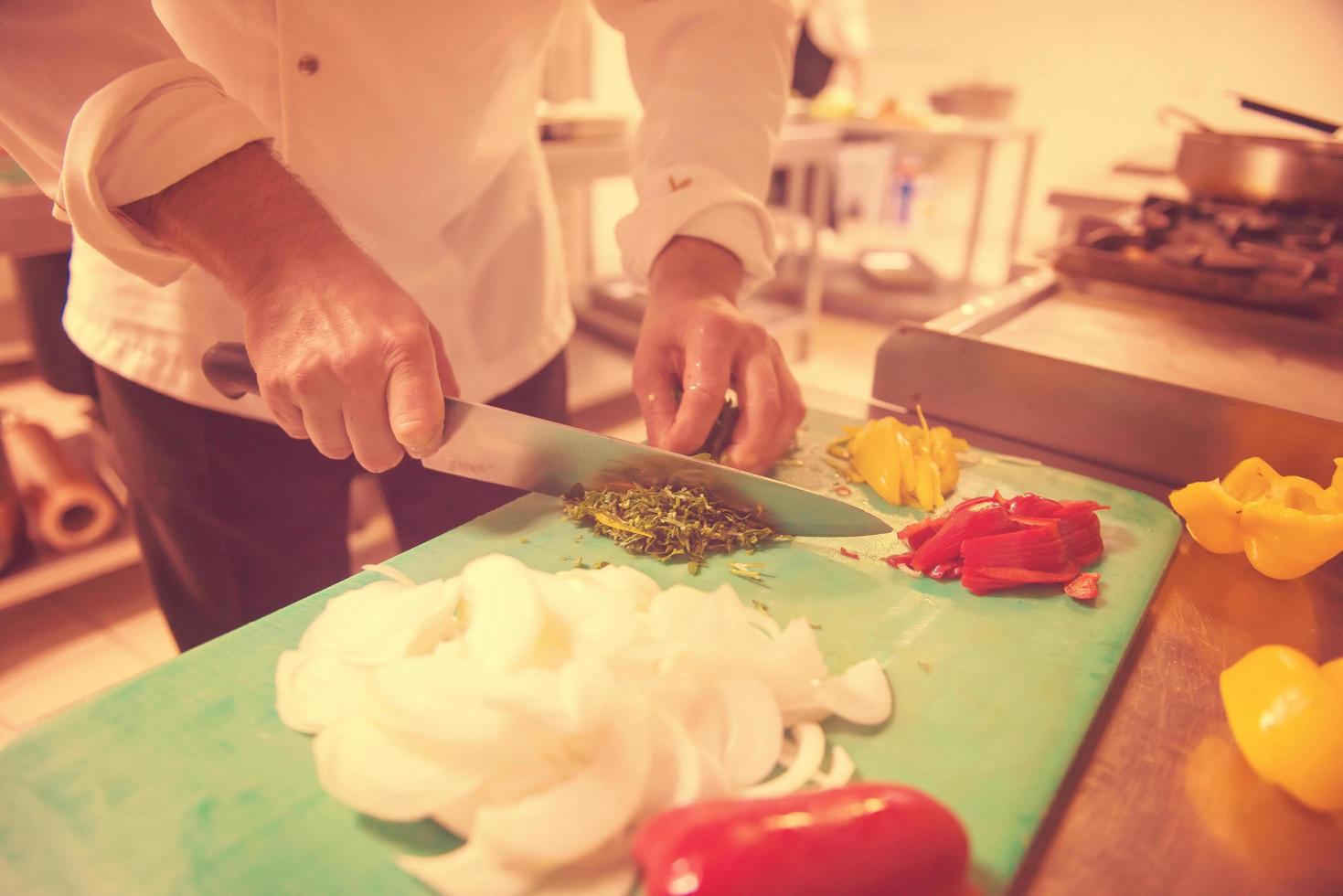 Chef hands cutting fresh and delicious vegetables photo