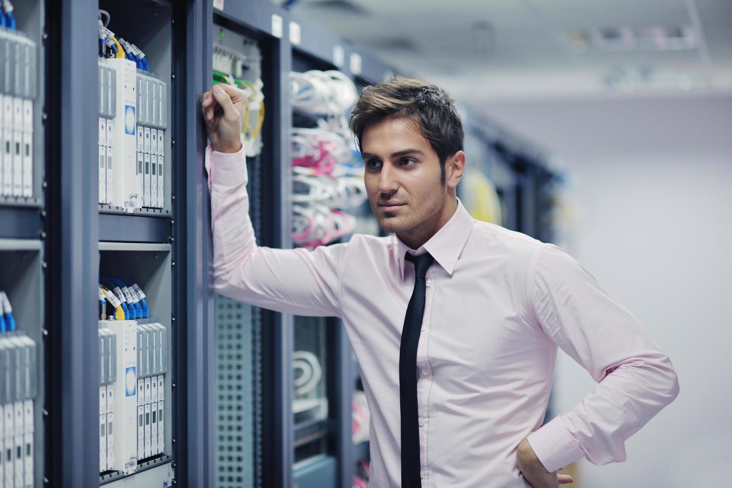 young it engeneer in datacenter server room photo